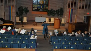 Shaun Garner directs RVUUF Choir in church's Great Hall