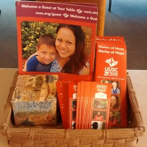 Basket displaying brochures that promote the 'Guest at Your Table' program