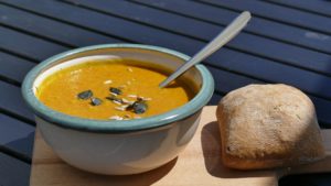 Bowl of pumpkin soup and ciabatta role