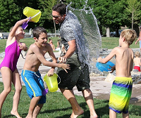 family playing water fight